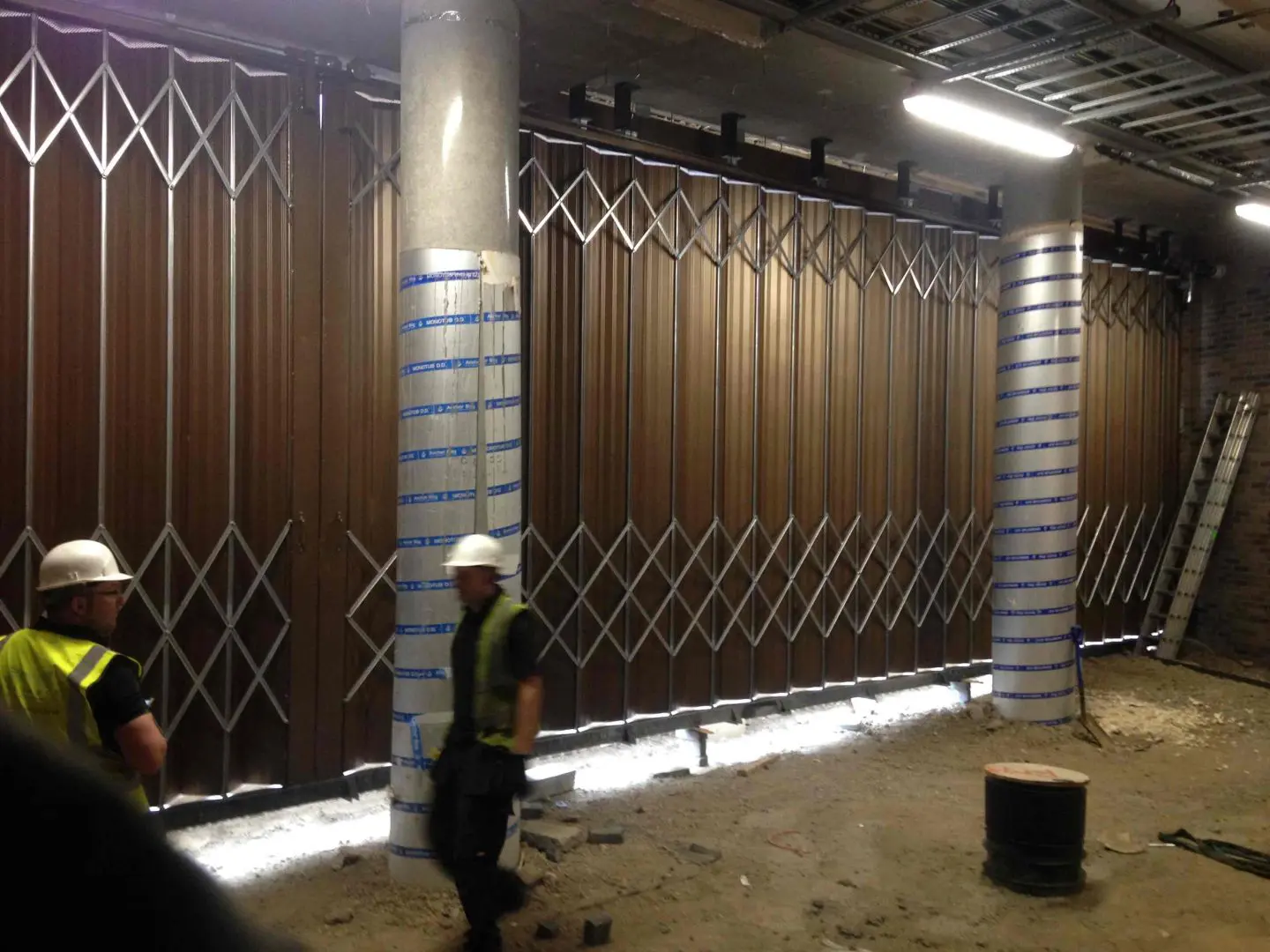Alliance Door Engineering fitting Ram-Fold Sliding, Folding Shutters in Stratford. Ram Fold Sliding Folding Shutter 43